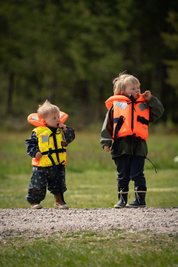 Twee kinderen in zwemvest klaar om te kanoen in de natuur van Zweden